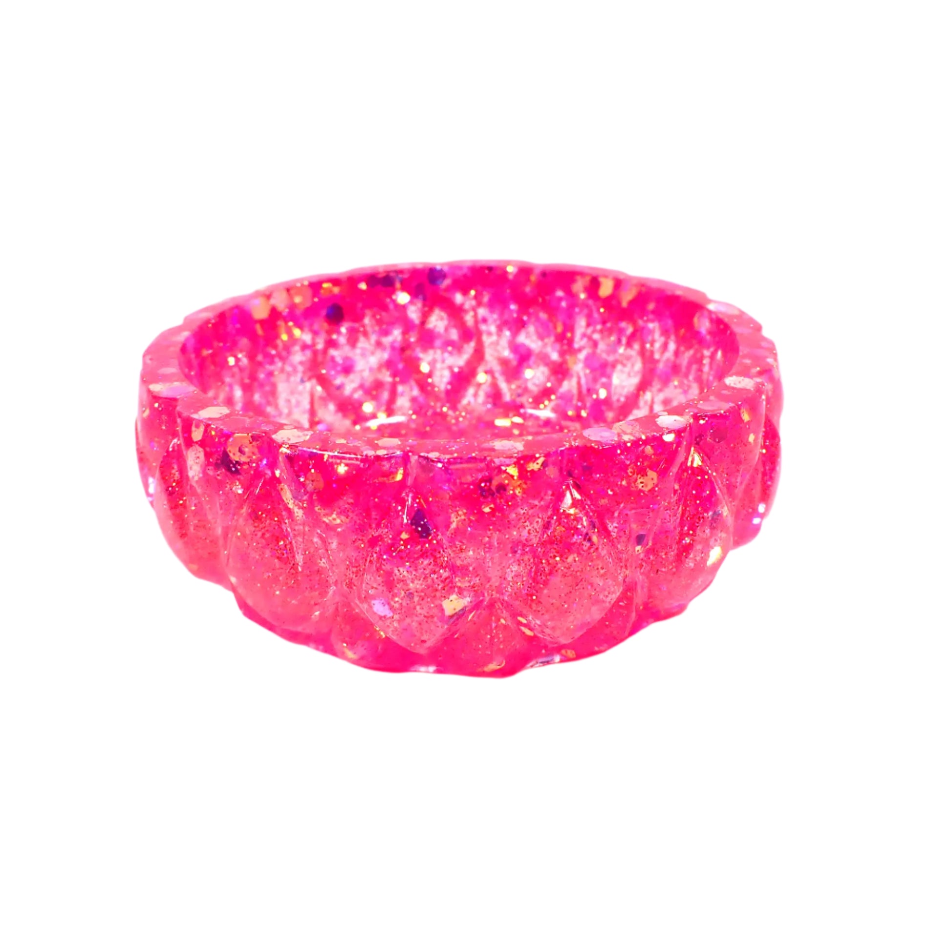 Side view of the handmade glitter resin ring dish showing more of the faceted design around the outer edge.