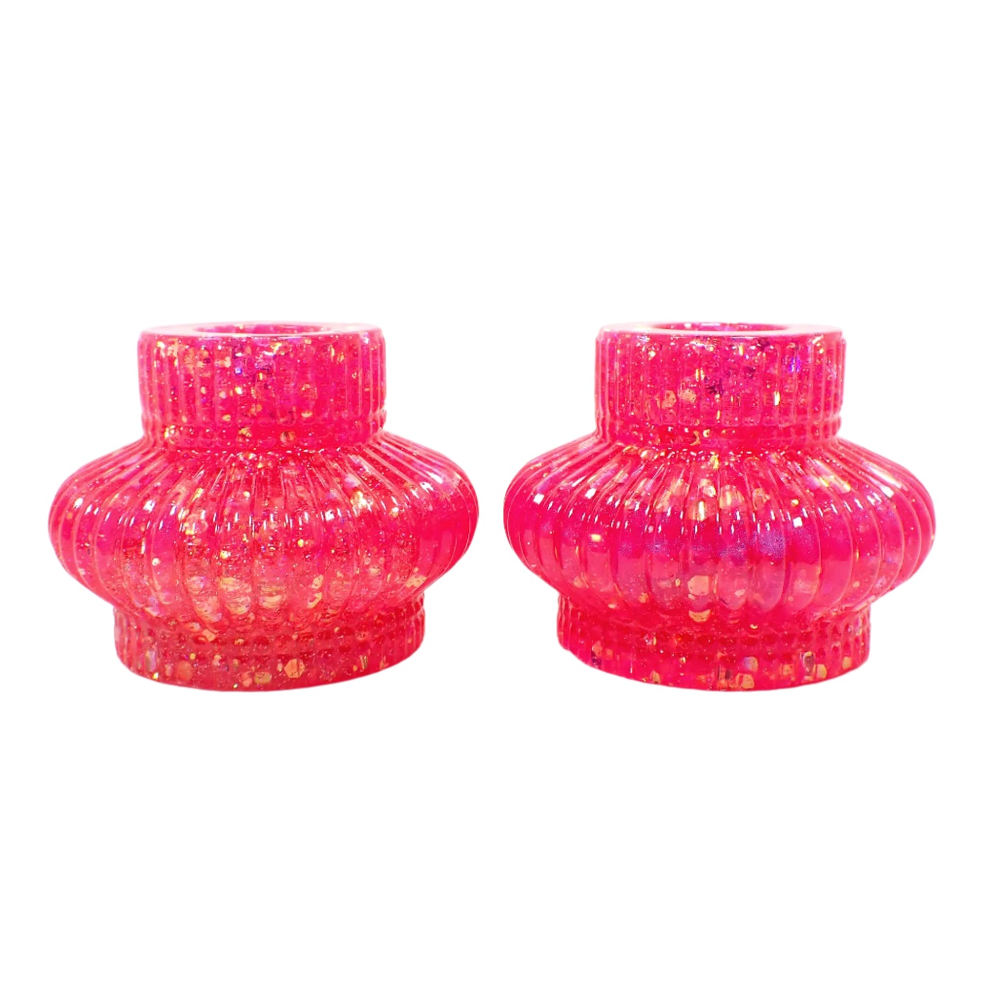 Side view of the handmade resin candle holders. The have a round corrugated top where the candles go, then a flared out corrugated saucer shape, and a corrugated round bottom. 