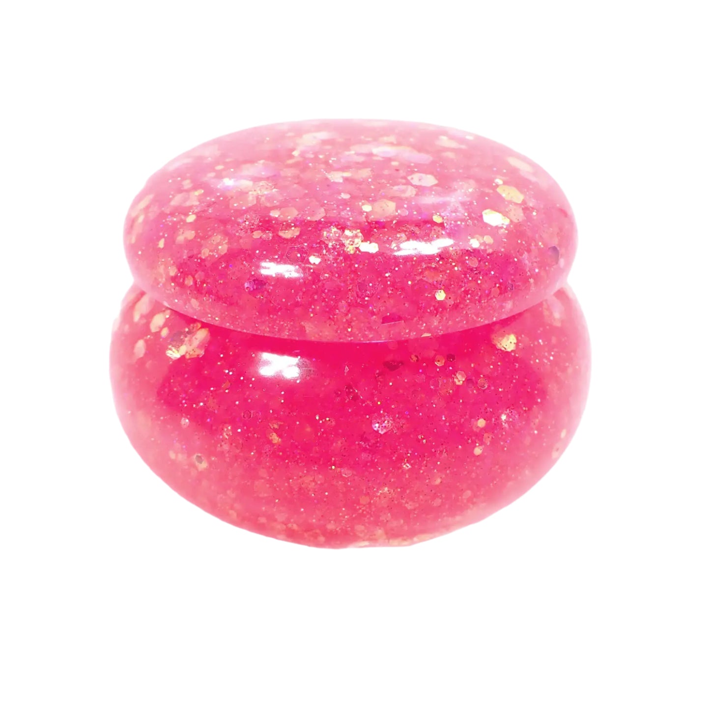 Another side view of the small handmade pink glitter resin trinket box. It has a round saucer like shape with a domed lid.