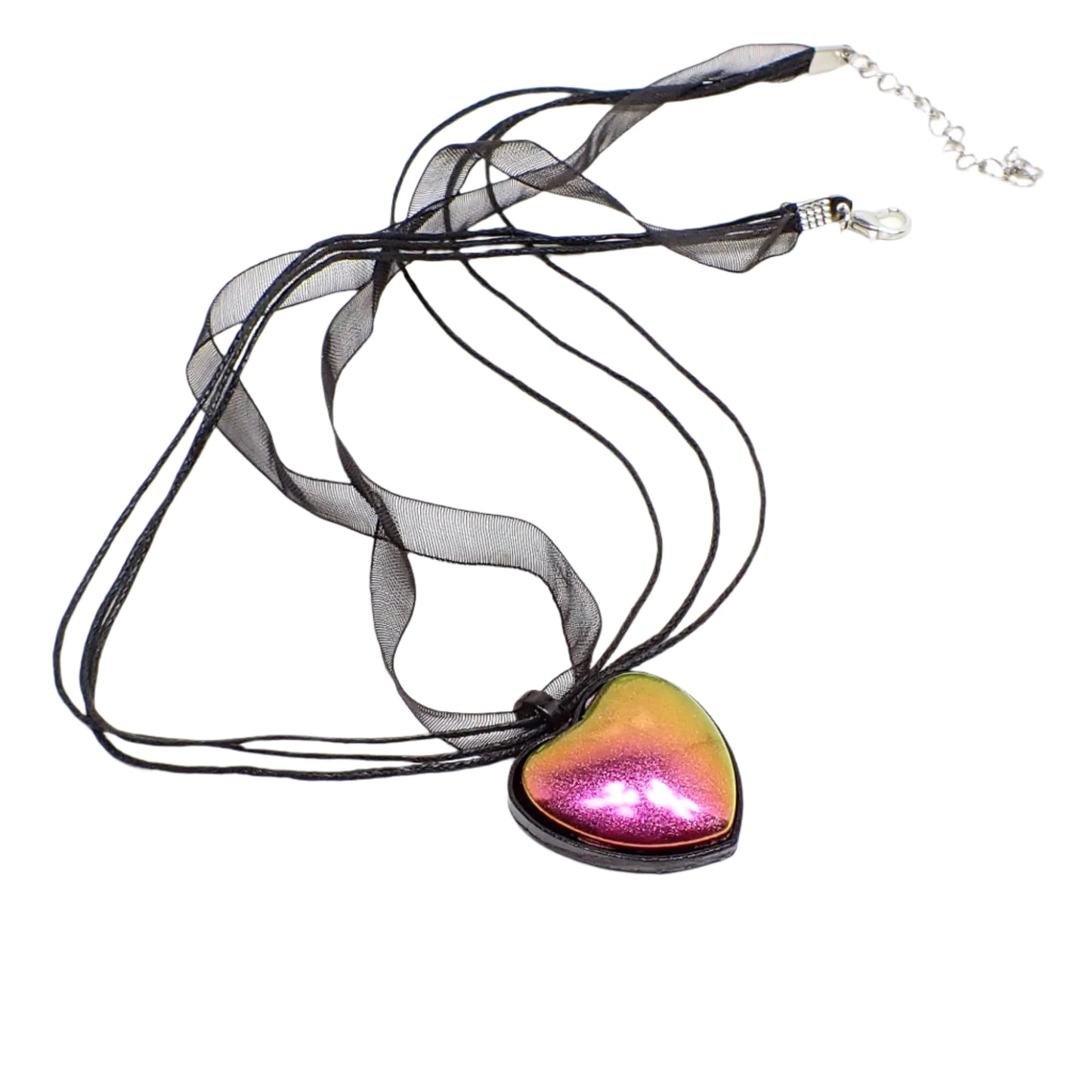 Another full view of the necklace. The matte metallic colors are bright against the black enameled heart setting.