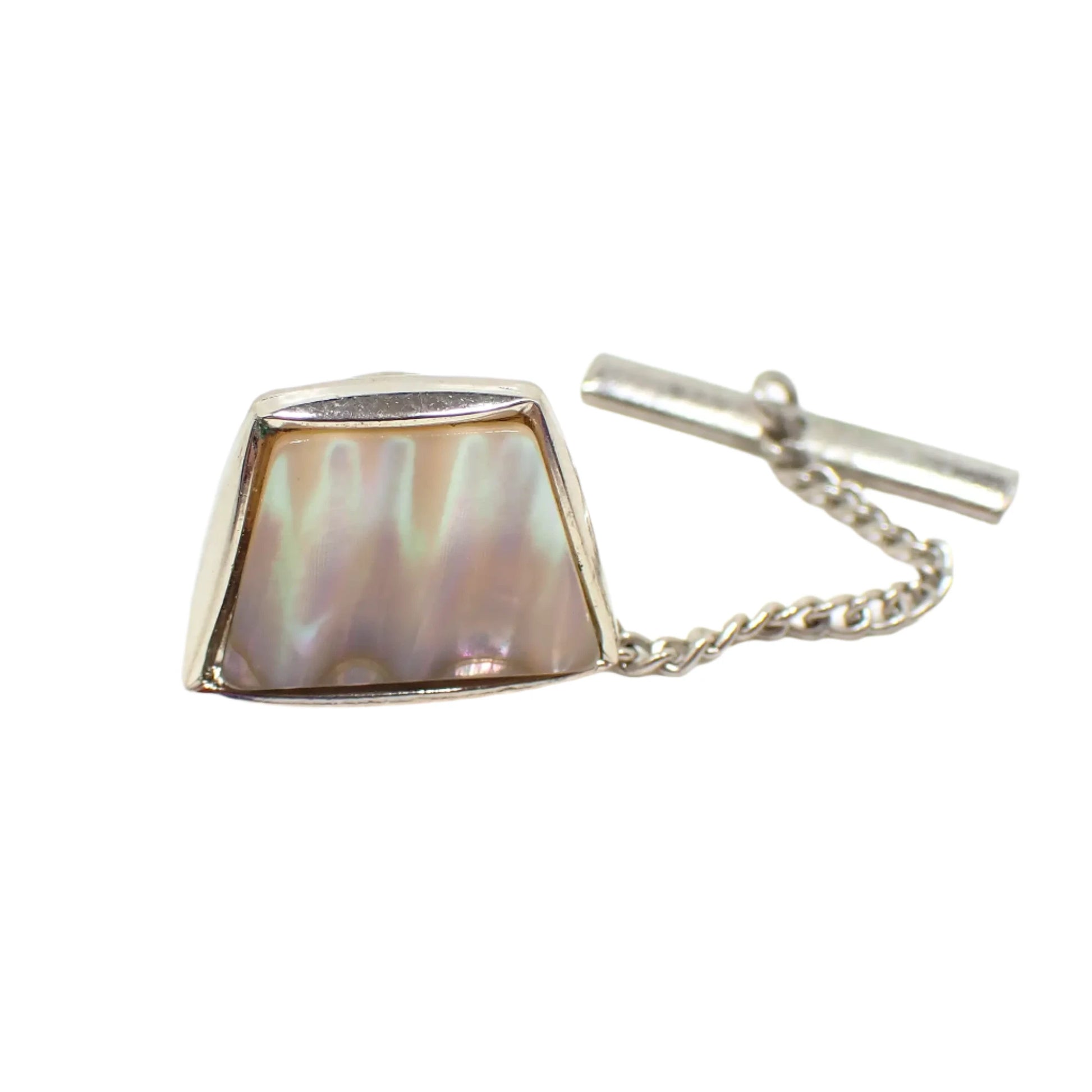 Photo of the entire vintage tie tack showing the chain coming from the clutch on the back. More flashes of color can be seen on the shell in this photo.