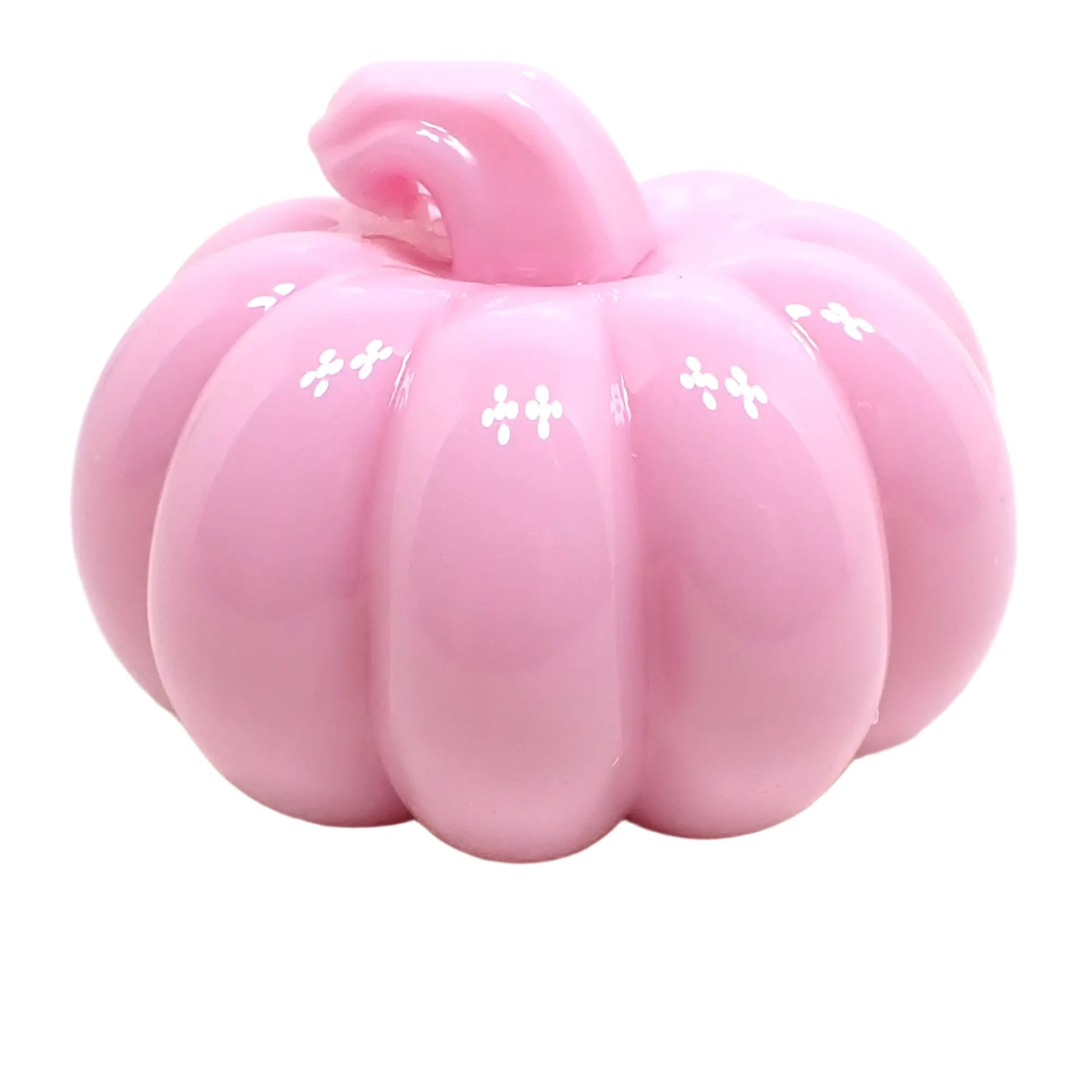 Angled view of the shiny resin pumpkin. It is pastel pink in color with a curved stem that has a flat top.