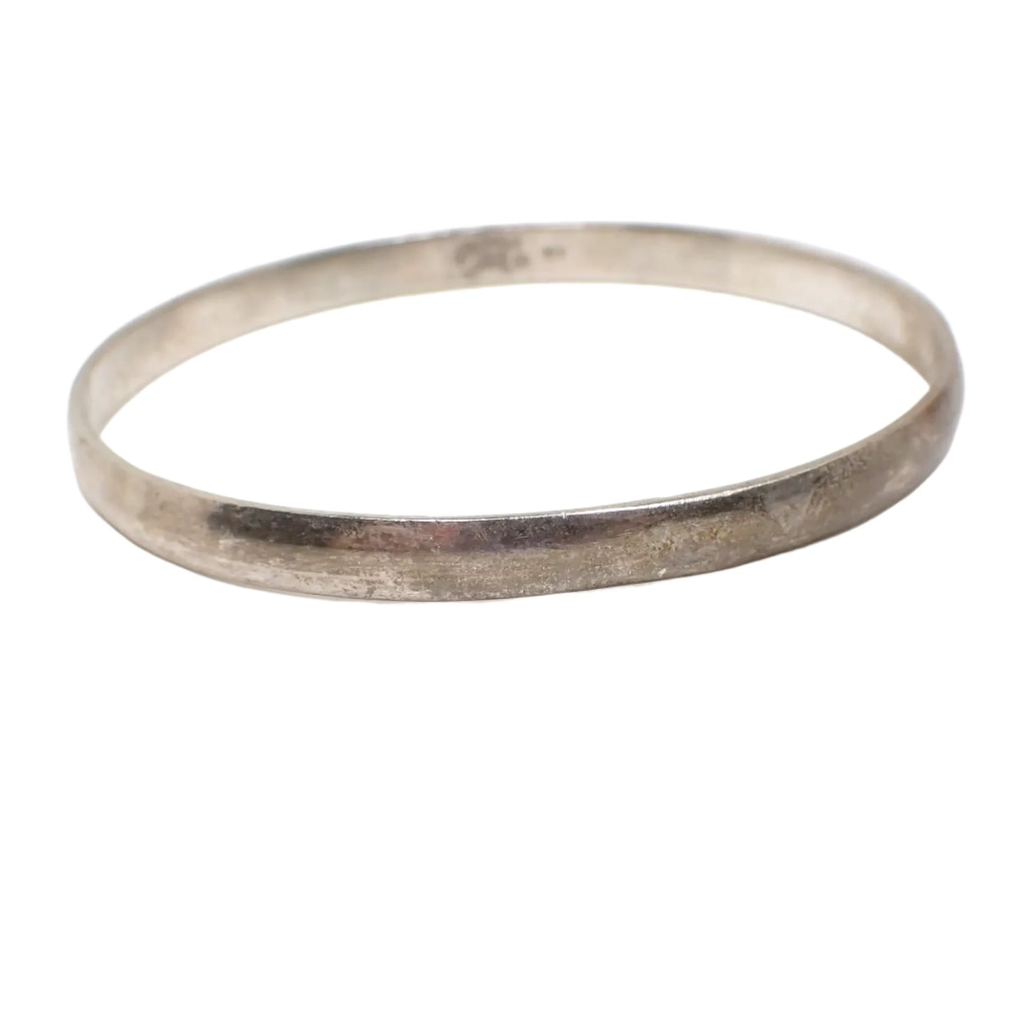 Side view of the bangle bracelet showing the darkened patina to an antiqued silver or gray in color.