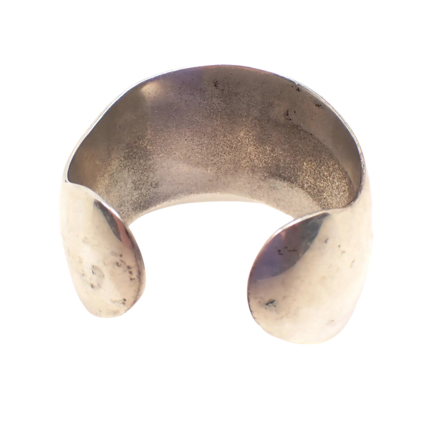 Back side of the wide sterling silver vintage cuff bracelet. Here the darker patina can be seen on the back inside area, especially in the middle.