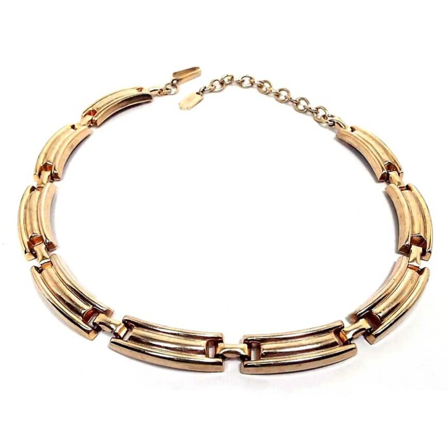 Front view of the Mid Century vintage Jaycraft link choker necklace. It is gold tone in color. There are curved rectangle links all the way to the hook clasp and chain end. There is a hang tag at the end of the chain.