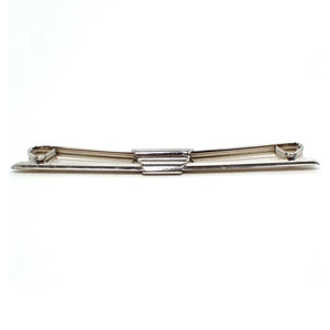 Front view of the Mid Century vintage collar clip. The front has an angled design with tapered ends. The back has angled curls at the ends. Collar stay is silver tone plated in color.