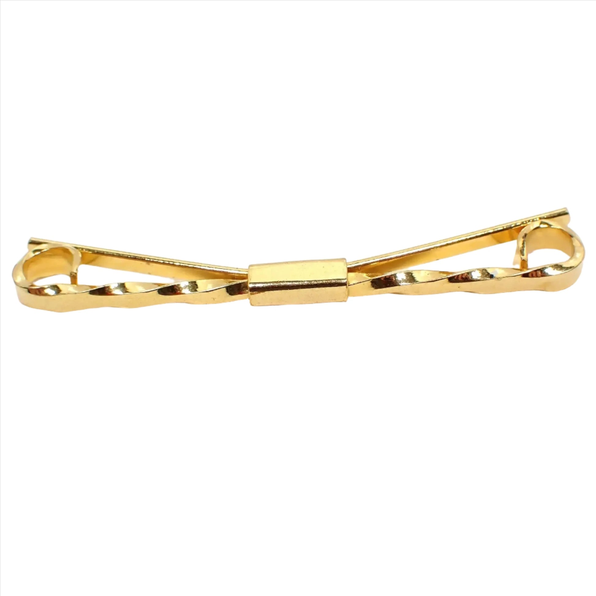 Enlarged front view of the retro vintage collar clip stay. The metal is gold tone plated in color. The front has a twisted design with curled ends.