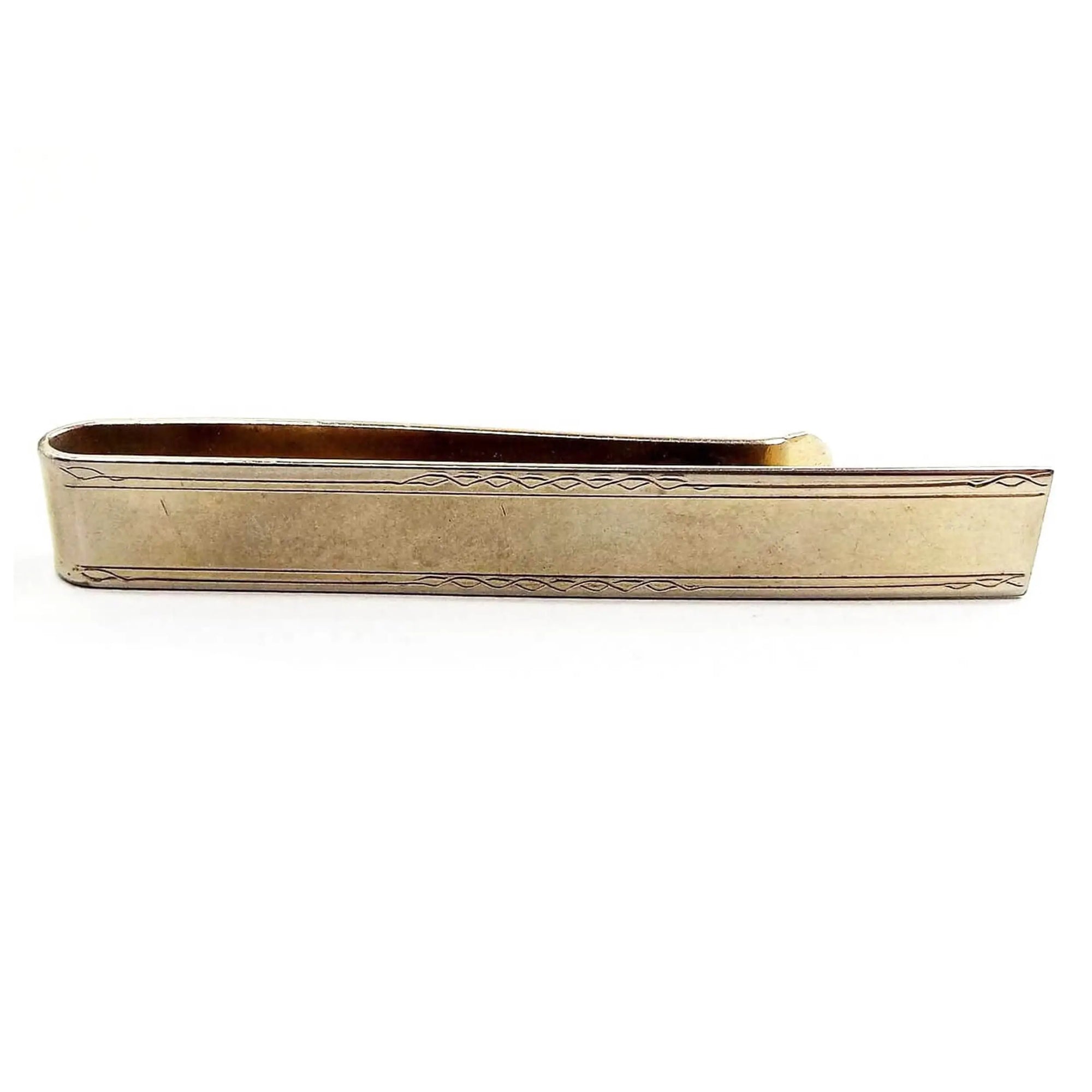 Front view of the Mid Century vintage slide on tie bar. It is a wide long rectangle shape has a light etched design on the edges. The metal is darkened gold tone in color.