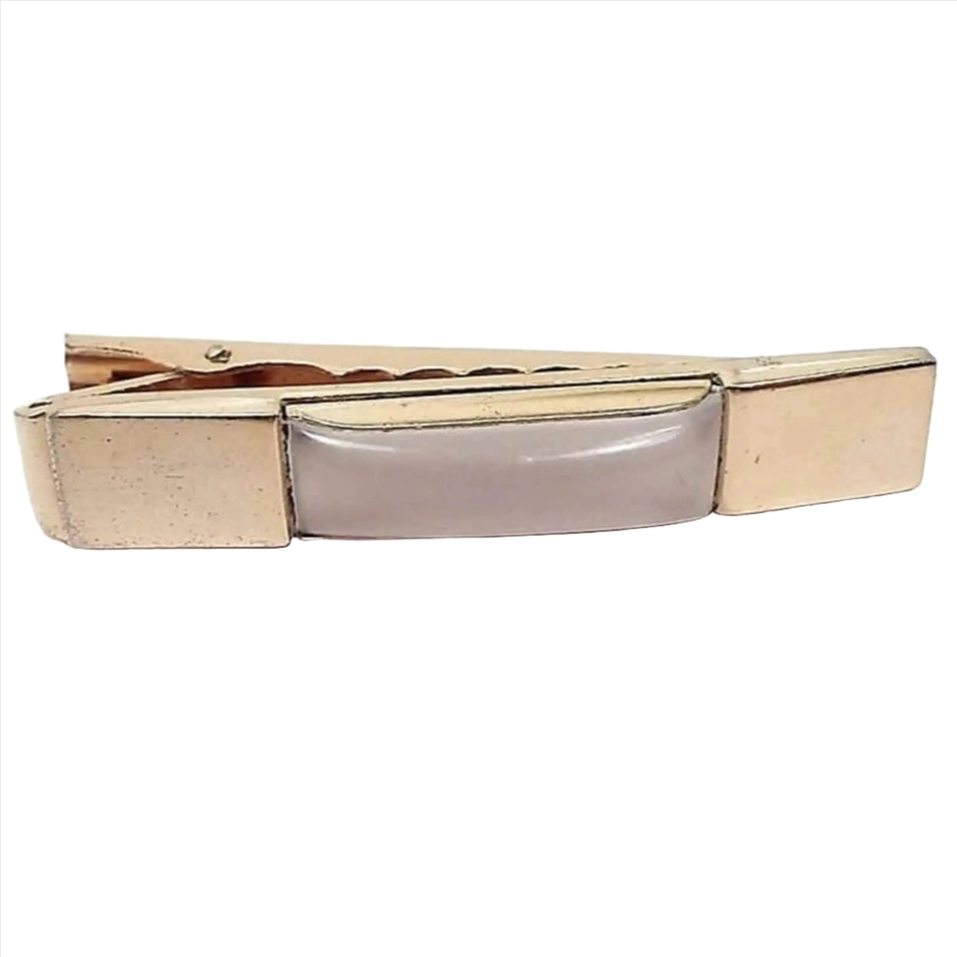 Front view of the Mid Century Anson tie clip. It has a rectangle shape with a puffy rectangle lucite plastic cab in the middle. The lucite is pearly white and slightly translucent in color. There is a large wide alligator style clip on the back.