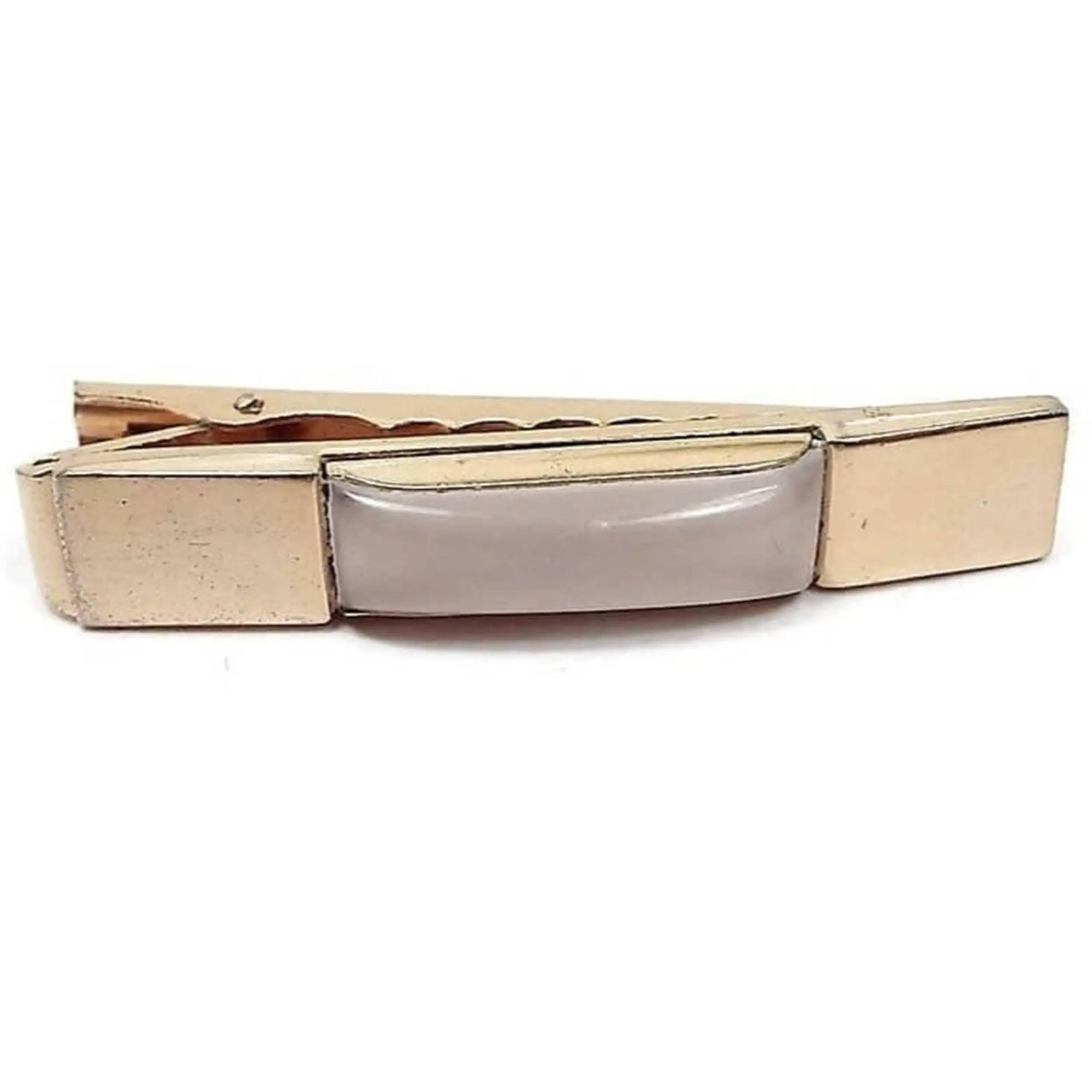 Front view of the Mid Century Anson tie clip. It has a rectangle shape with a puffy rectangle lucite plastic cab in the middle. The lucite is pearly white and slightly translucent in color. There is a large wide alligator style clip on the back.