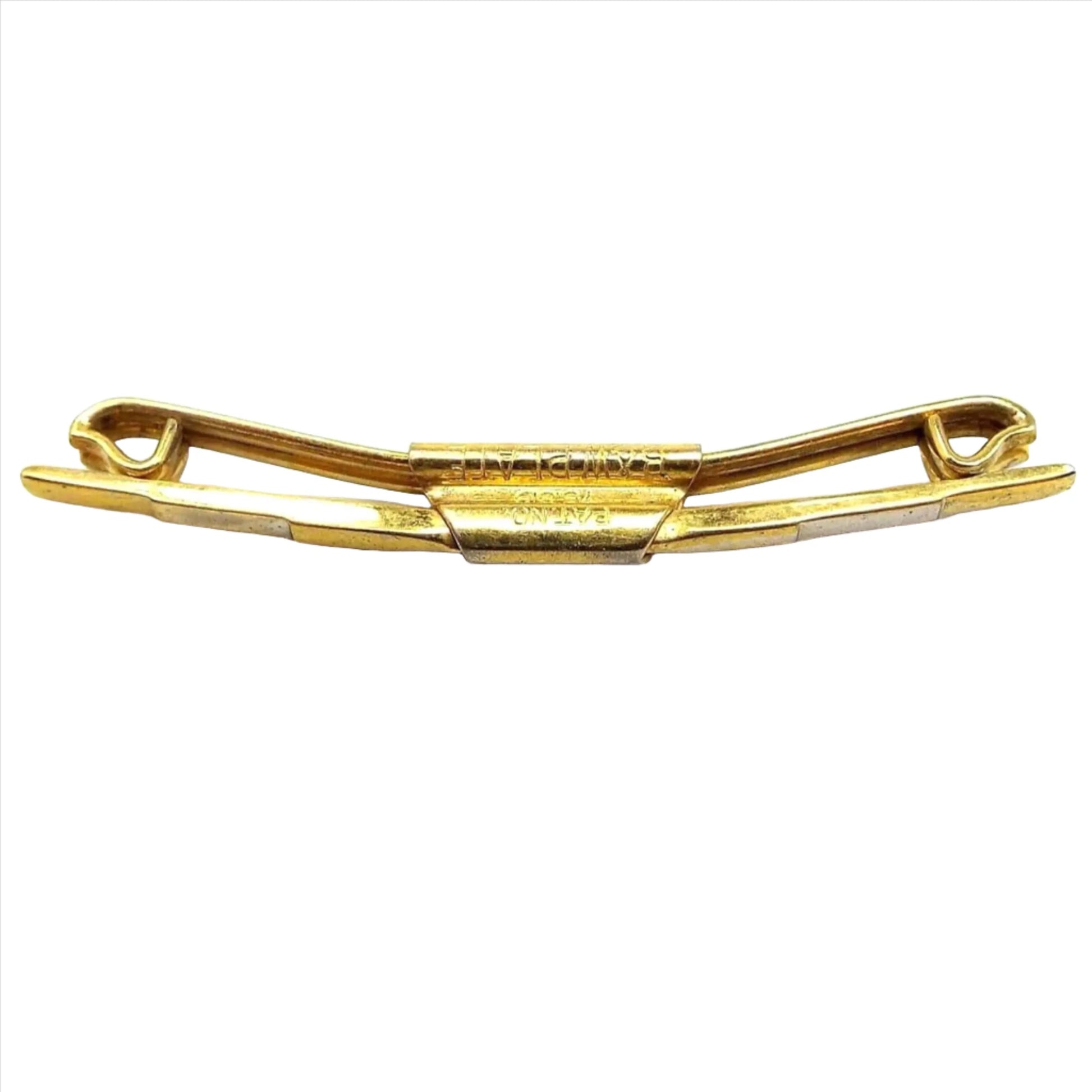 Front and side view of the 1920's Art Deco vintage Swank collar clip bar. The metal is gold tone in color. The front bar has a step like design on the front where each area is raised more until you get to the middle. The back bar has ends that are curled inwards. Stamped on the side is Pat. No 75818 B&W plate.