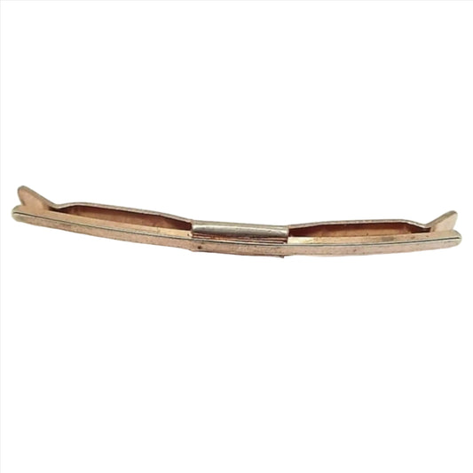 Front view of the Mid Century vintage Hayward collar bar clip. It is gold tone in color and has a basic design of a curved front bar with squared off ends. The back bar is curved with angled ends. Both sides are held together with a middle rectangle piece.