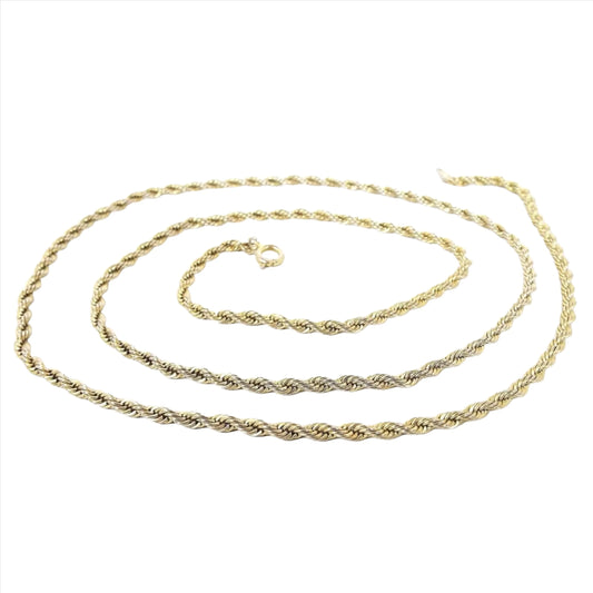 Angled top and side view of the retro vintage rope chain necklace. The metal is gold tone color. The chain has a twisted rope design with a round spring ring clasp at the end.