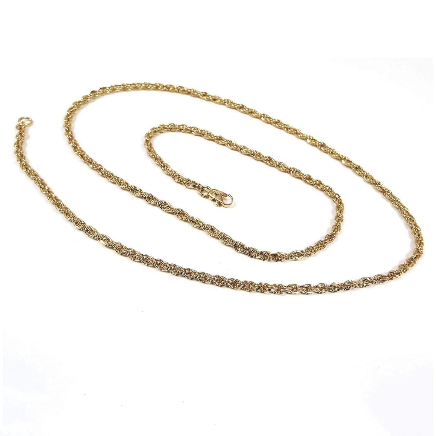 Top view of the retro vintage chain necklace. The metal is gold tone in color. It has a rope chain design with a small lobster claw clasp on the end.