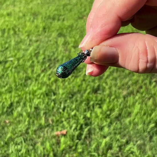 Gunmetal Plated Small Handmade Green Glitter Teardrop Earrings video showing how the glitter sparkles.