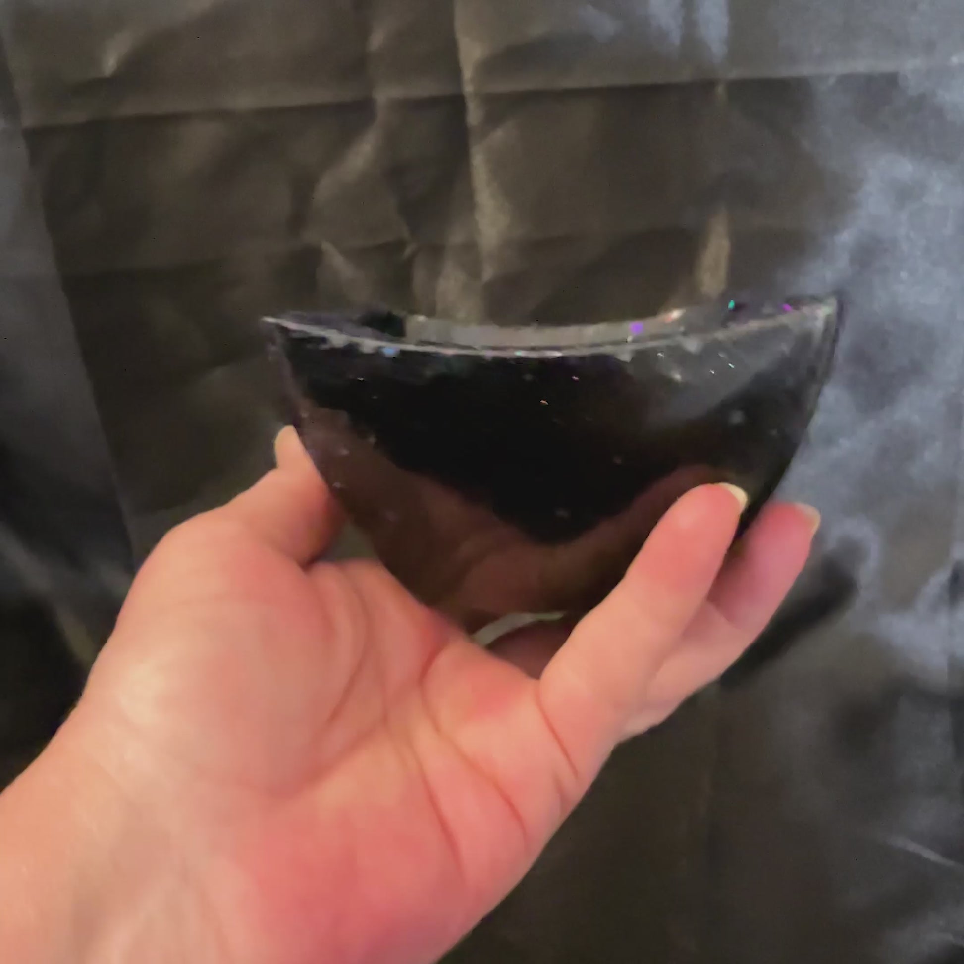 video of the black resin glitter angled bowl showing how the glitter sparkles in the light.