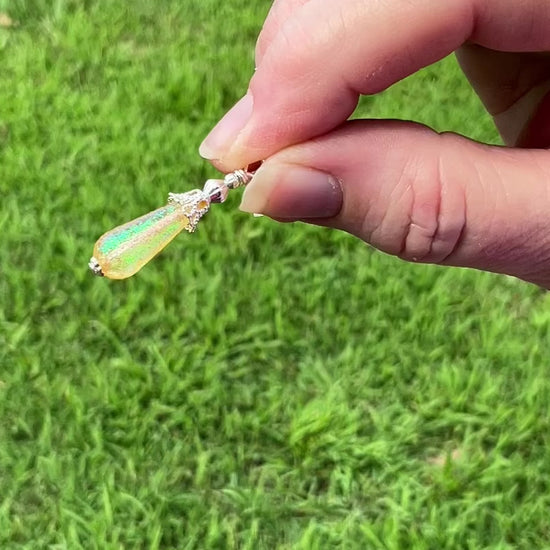 Small Silver Plated Handmade Yellow Glitter Lucite Teardrop Earrings video showing how the glitter sparkles in the light.