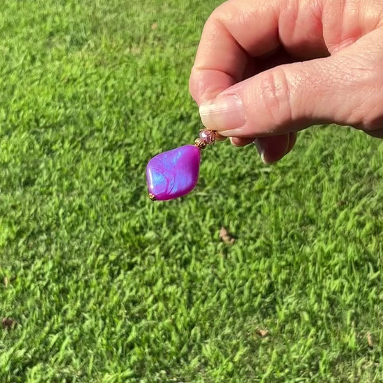 Gold Plated Handmade Color Shift Purple Lucite Earrings video showing how the color has a shift sheen of purple and blue as it moves around in the light.