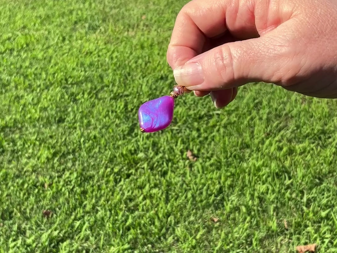 Gold Plated Handmade Color Shift Purple Lucite Earrings video showing how the color has a shift sheen of purple and blue as it moves around in the light.