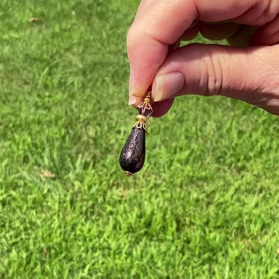 Dark Purple Glitter Handmade Teardrop Earrings video showing how the glitter sparkles in the light.