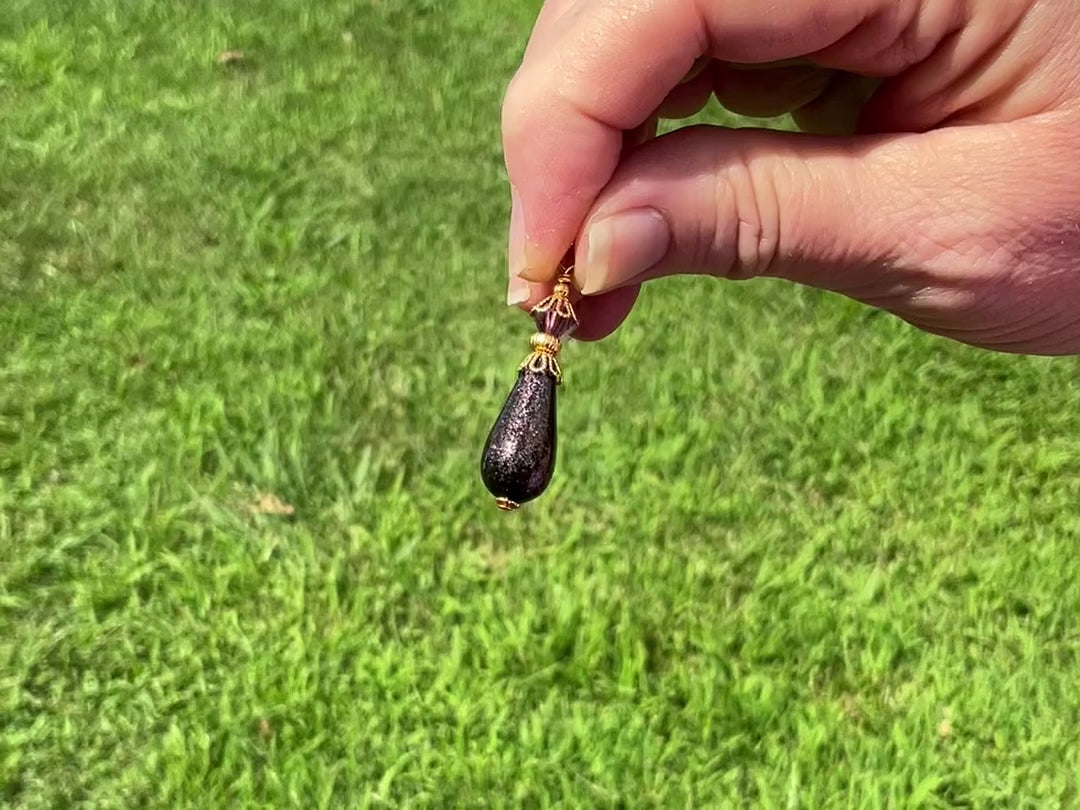 Dark Purple Glitter Handmade Teardrop Earrings video showing how the glitter sparkles in the light.