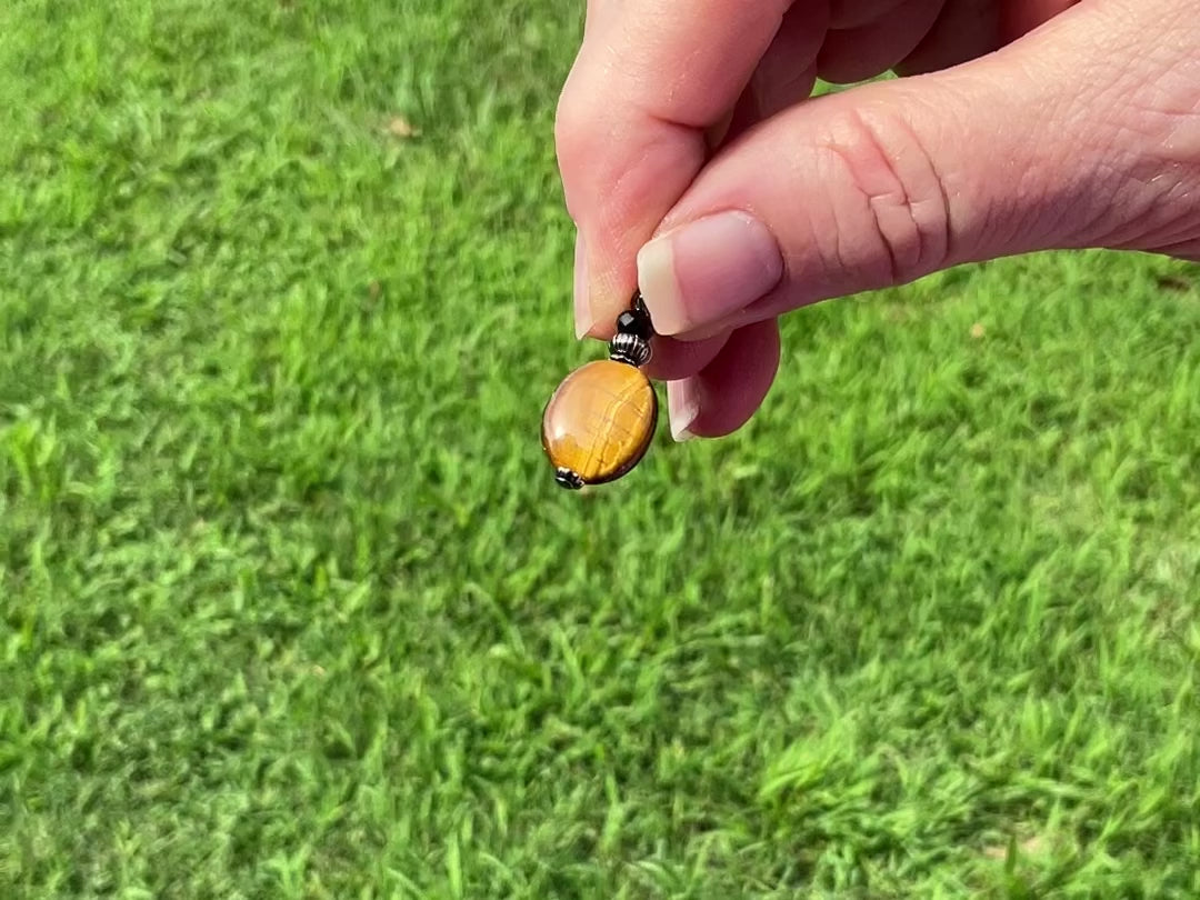 Gunmetal Plated Tiger's Eye Gemstone Handmade Earrings video showing how the gemstone has flashes of chatoyancy and color as it moves around in the light.