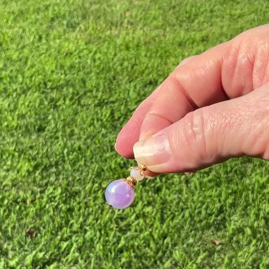 Gold Plated Handmade Pearly Iridescent Purple Drop Earrings video showing how the colors flash as the earrings move around in the light.