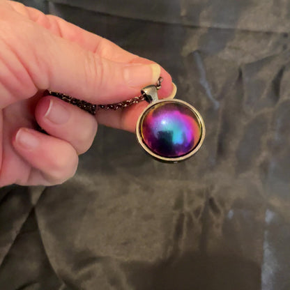 Video of the color shift pendant necklace showing how the colors shift through pink, blue, purple, and yellow.