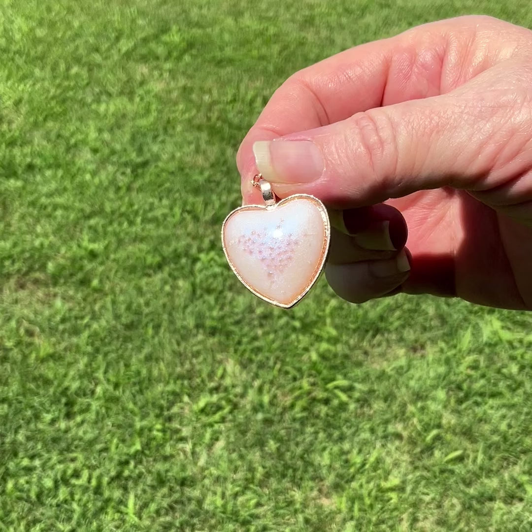 Handmade Rose Gold Plated Pink Bubble and Blue Color Shift Resin Heart Pendant Necklace video showing how the blue sheen shows when moving around in the light.