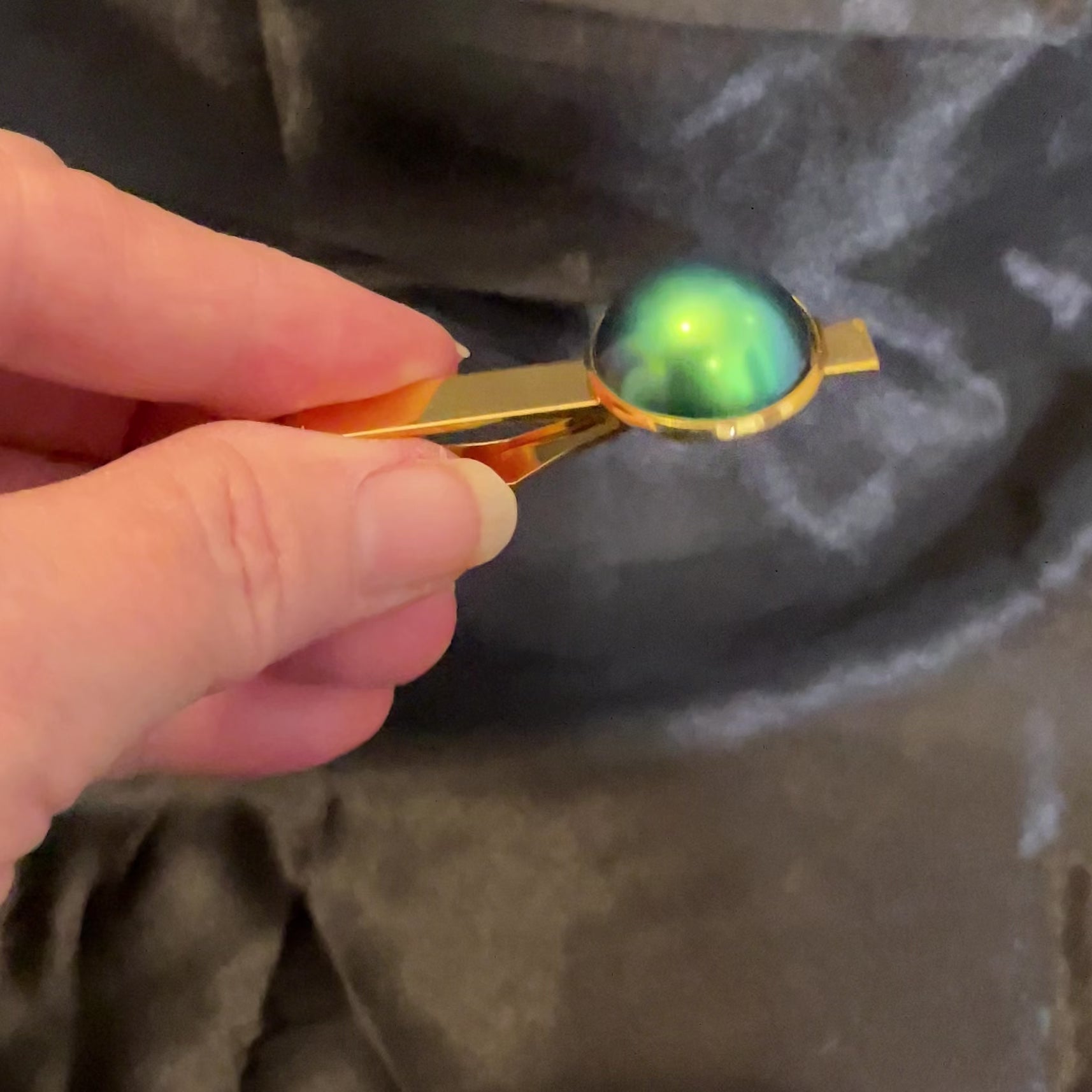 Video of the color shift tie clip showing how it shifts between blue and green as the light hits it.