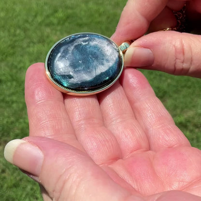  Large Oval Handmade Abstract Blue Frost Resin Pendant Necklace video showing how the iridescent background shimmers and changes shade in the light.