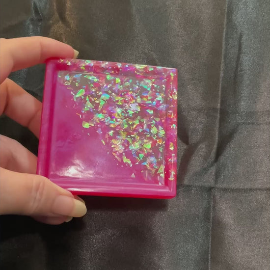 Video of the small handmade bright pink square trinket dish tray showing how the iridescent glitter sparkles in the light.