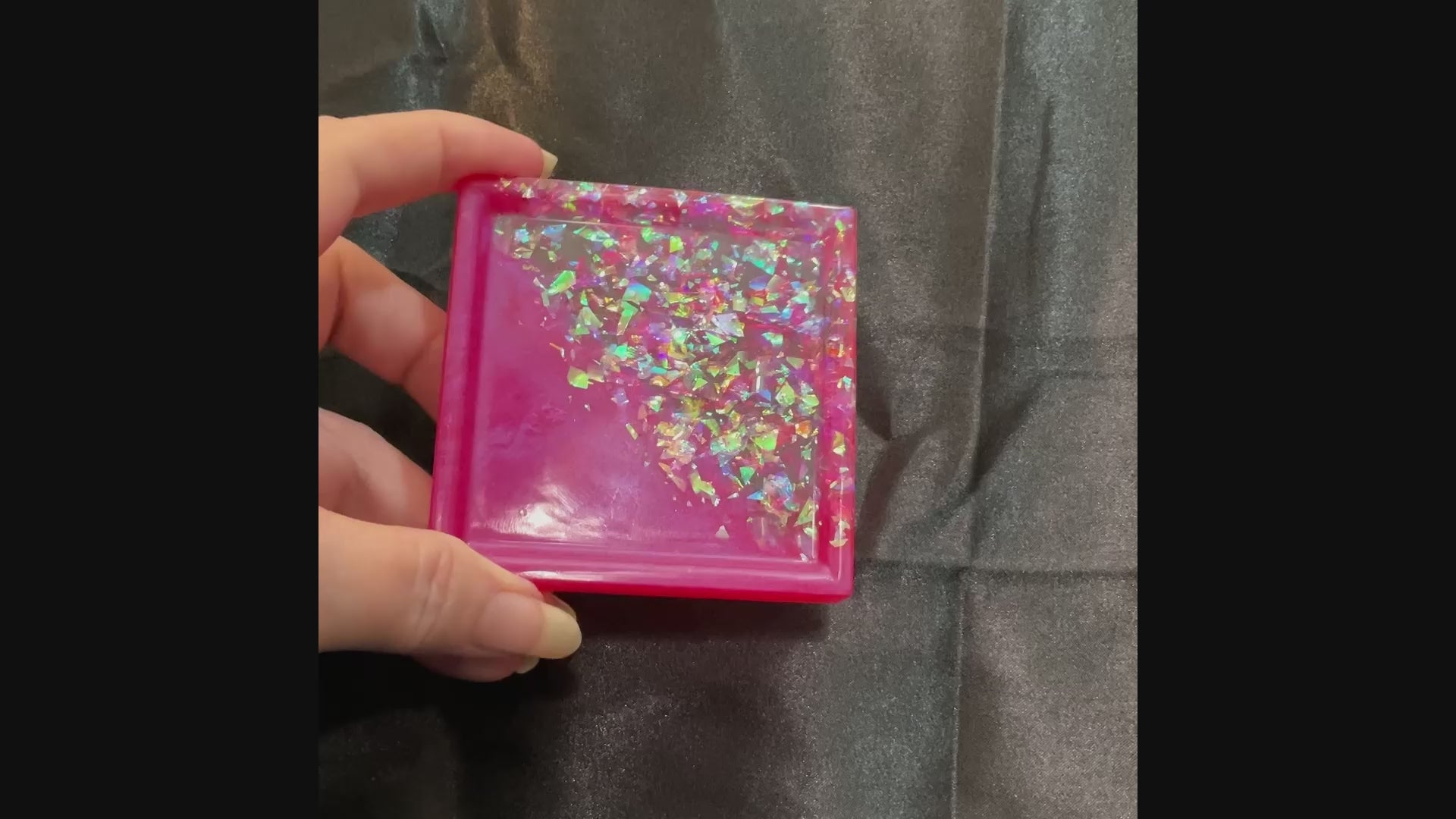 Video of the small handmade bright pink square trinket dish tray showing how the iridescent glitter sparkles in the light.