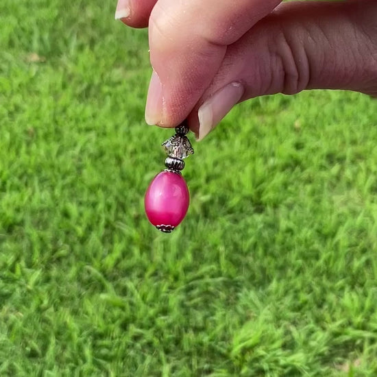 Gunmetal Raspberry Pink Moonglow Lucite Handmade Oval Drop Earrings video showing how the lucite has a glow like effect in the light. 