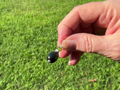 Silver Plated Handmade Olive Green Moonglow Lucite Drop Earrings video showing how the lucite has a glowy effect in the light.