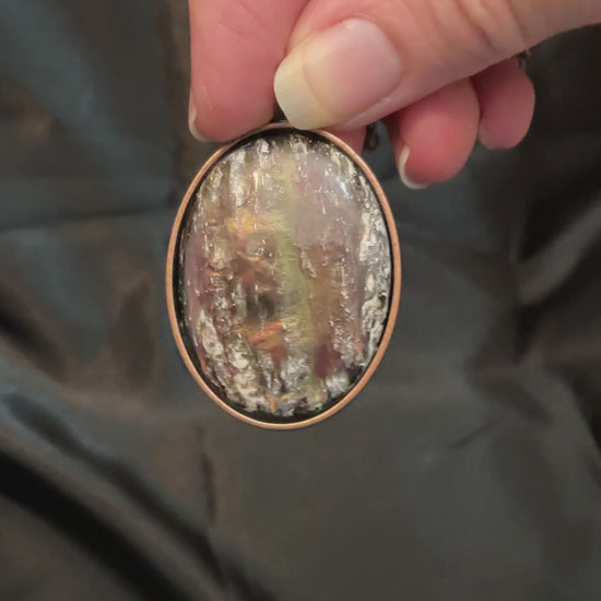 Video showing how the antiqued copper abalone and resin vintage cab on the handmade oval pendant necklace is iridescent and shimmers in the light.