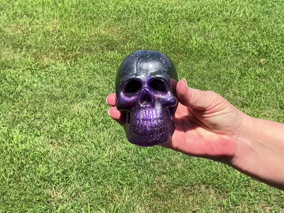 Large Black Gray and Dark Purple Handmade Resin Skull with Holographic Glitter video showing how the glitter sparkles in the light. Video was taken outside.
