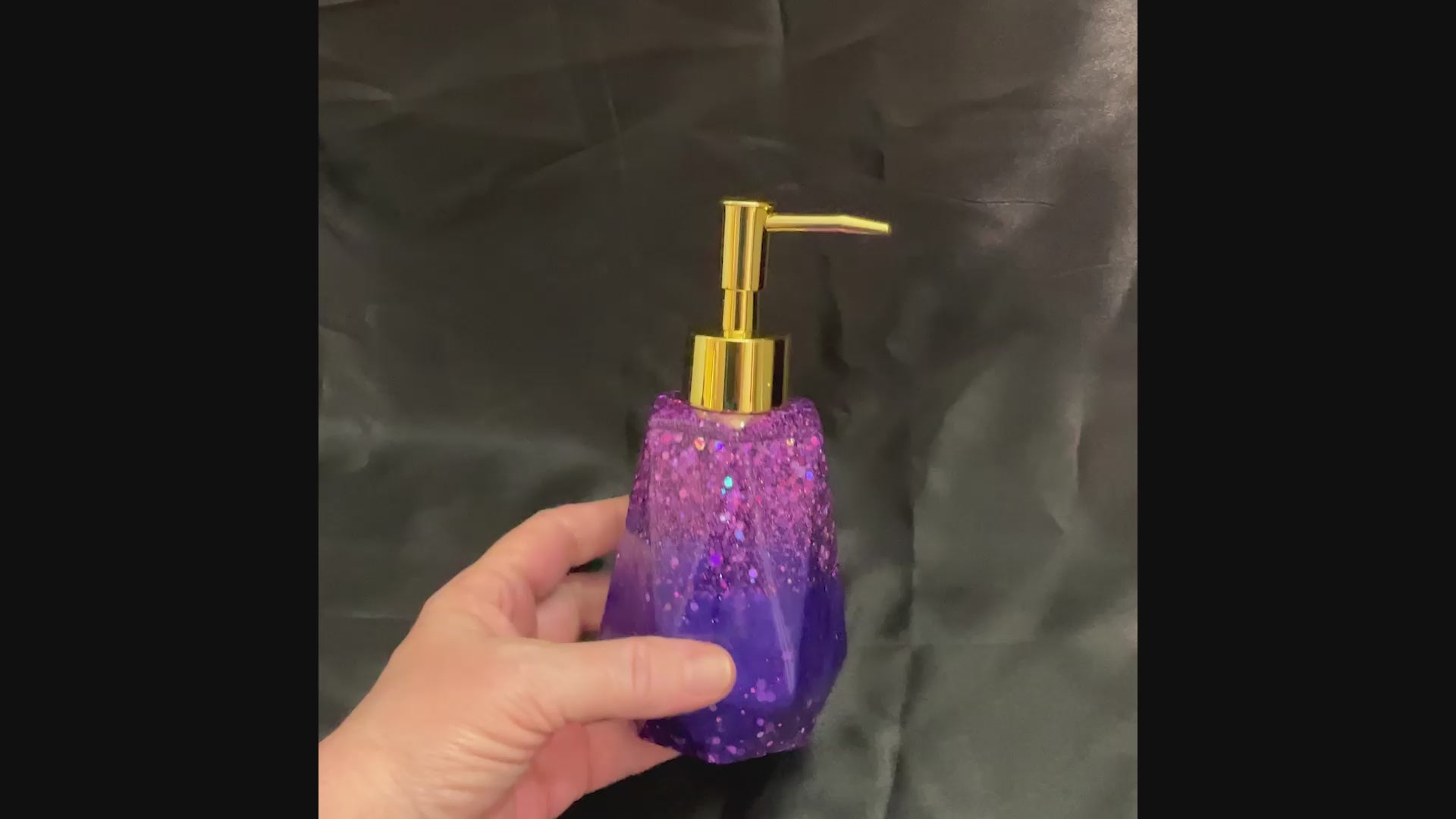 Video of the purple resin handmade faceted soap dispenser showing how the glitter sparkles in the light.