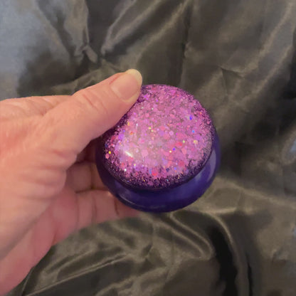 Video showing how the glitter on the small round handmade trinket box sparkles in the light.