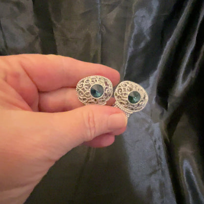 Video of the Mid Century vintage Swank filigree cufflinks showing how the blue rivoli rhinestones sparkle in the light.