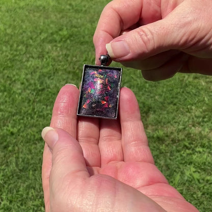 Large Handmade Purple Resin Rectangle Pendant Necklace with Chunky Iridescent Glitter video showing how the glitter flashes and changes colors as it moves around in the light.