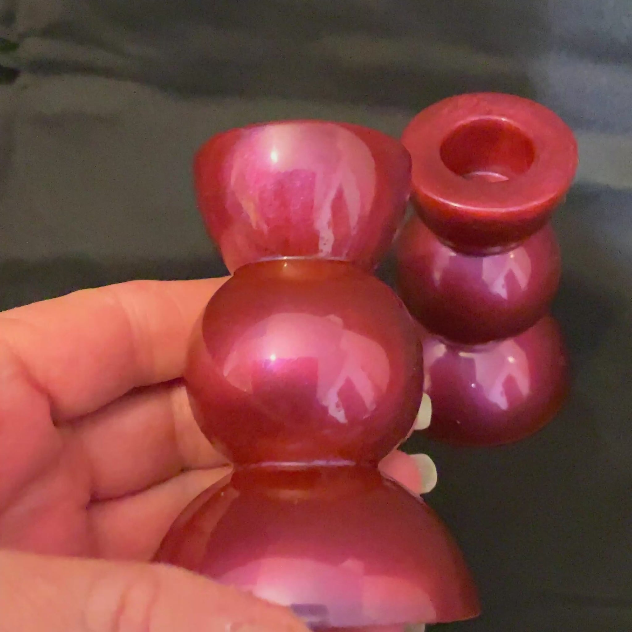 Handmade Pearly Color Shift Sunset Resin Rounded Geometric Candlestick Holders video showing how the different colors of red, orange, pink, and purple flash when moving around in the light.