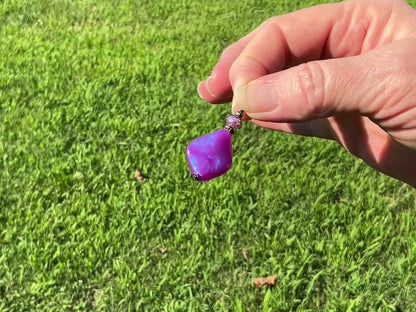 Gunmetal Handmade Color Shift Purple Lucite Earrings video showing how the color has a shift sheen of purple and blue as it moves around in the light.