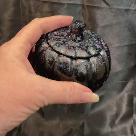 Video of the handmade black resin pumpkin trinket box decorative jar showing how the glitter sparkles in the light.