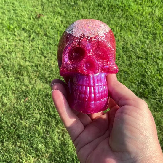 Handmade Bright Pink Resin Skull with Iridescent Glitter video showing how the glitter sparkles in the light.