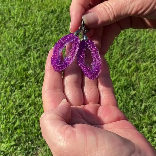 Faux Geode  Slice Style Fuchsia Iridescent Glitter Resin Handmade Earrings video showing how the glitter sparkles as they move around in the light.