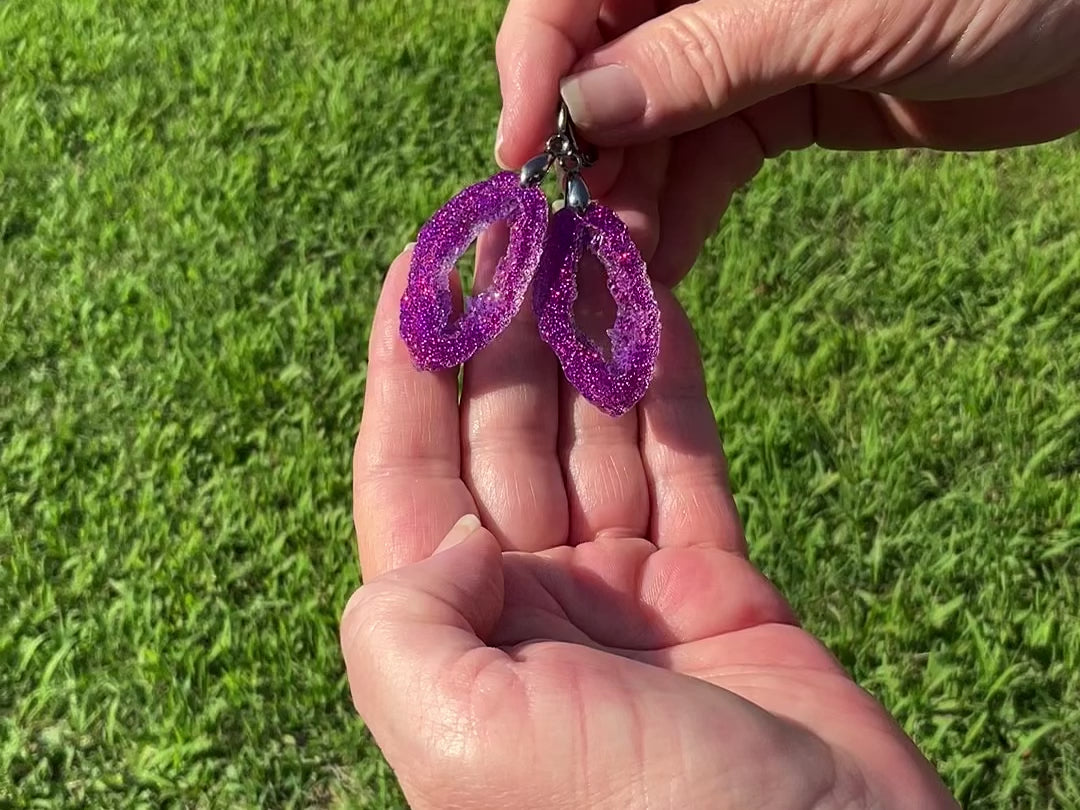 Faux Geode  Slice Style Fuchsia Iridescent Glitter Resin Handmade Earrings video showing how the glitter sparkles as they move around in the light.