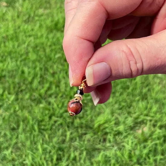 Gold Plated Small Handmade Goldstone and Black Marbled Drop Earrings video showing how the glitter sparkles in the light.