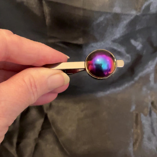 Video showing how the cab on the gunmetal color shift tie clip goes from blue to pink and purple and sometimes other colors as the light hits it.