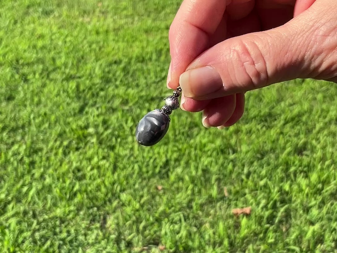 Gunmetal Plated Pearly Gray Oval Drop Lucite Handmade Earrings video showing how they have a pearly glow like effect in the light.